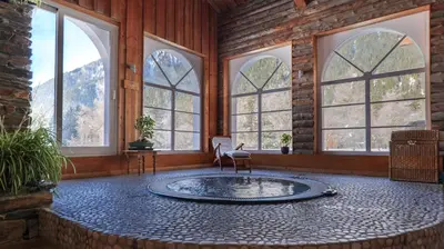 a room with a circular pool in a room with windows at Hôtel Le Labrador in Chamonix-Mont-Blanc