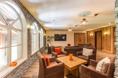 a living room with couches and a table at Hôtel Le Labrador in Chamonix-Mont-Blanc