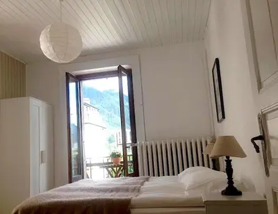 a bedroom with a bed and a large window at Appartement Alexandra in Chamonix-Mont-Blanc