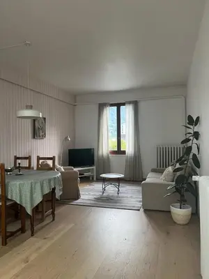 a living room with a table and a couch at Appartement Alexandra in Chamonix-Mont-Blanc