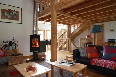 a living room with a wood burning stove at Chalet Brio in Samoëns