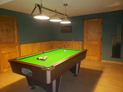 a pool table in a room with a green cloth at Chalet Brio in Samoëns