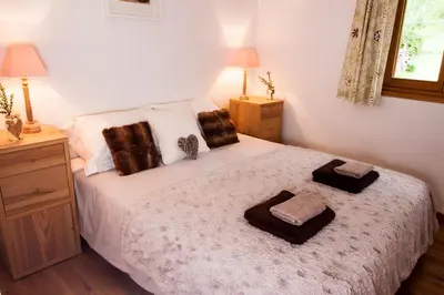 a bedroom with a bed with two towels on it at La Terrasse - 3 bedrooms with private Hot Tub in Samoëns