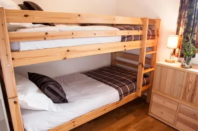 a couple of bunk beds in a room at La Terrasse - 3 bedrooms with private Hot Tub in Samoëns