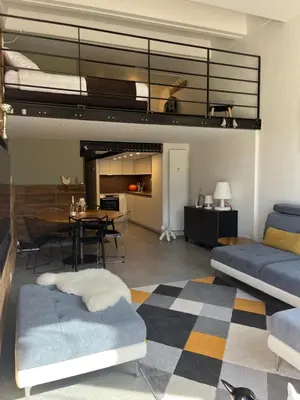 a living room with a bed and a dining room at Flaine Forum H1 Cassiopée Mezzanine & Terrasse in Flaine