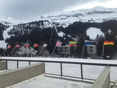 a group of flags in front of a mountain at Flaine Forum H1 Cassiopée Mezzanine & Terrasse in Flaine