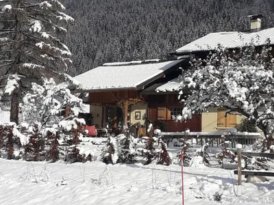 a ski lodge with snow on the ground in front of it at Casa Mia in Saint-Gervais-les-Bains