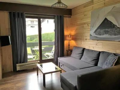 a living room with a couch and a table at Les Esserts in Les Houches
