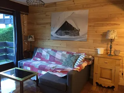 a living room with a couch and a table at Les Esserts in Les Houches