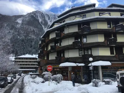 a large building with snow in front of a mountain at Art Studio in Chamonix-Mont-Blanc