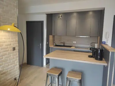 a kitchen with a counter and stools in a room at Central Sweet Home in Saint-Gervais-les-Bains