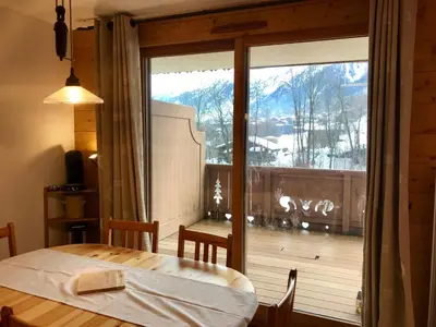 a room with a table and a large glass window at Kandahar in Les Houches