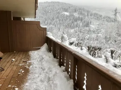 a balcony covered in snow with a view of a mountain at Kandahar in Les Houches