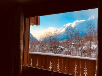 a window with a view of a snow covered mountain at Kandahar in Les Houches