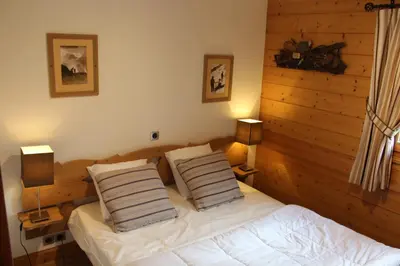 a bedroom with a bed with two pillows on it at Reine des Prés in Samoëns