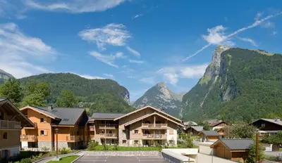 a view of a resort with mountains in the background at Reine des Prés in Samoëns