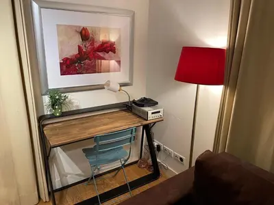 a room with a desk with a lamp and a picture at Biolay 1 in Chamonix-Mont-Blanc