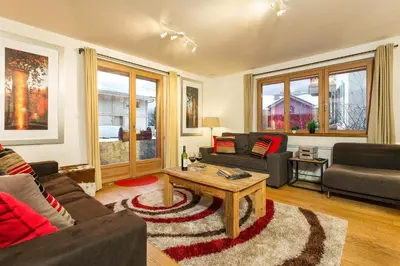 a living room with a couch and a coffee table at Biolay 1 in Chamonix-Mont-Blanc