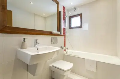 a bathroom with a sink and a toilet and a mirror at Biolay 1 in Chamonix-Mont-Blanc