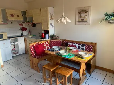 a kitchen with a table and chairs and a table at Savran in Saint-Gervais-les-Bains