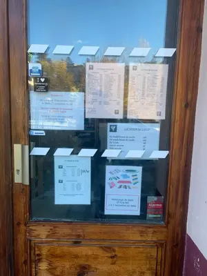 a glass door with signs on it at Savran in Saint-Gervais-les-Bains