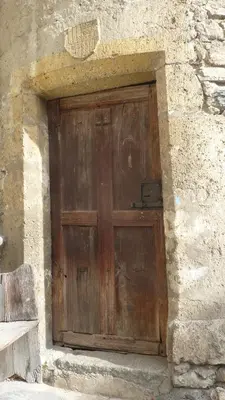 a wooden door on the side of a stone building at appartement château de la Comtesse in Saint-Gervais-les-Bains