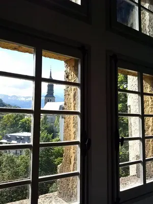 a window with a view of a building at appartement château de la Comtesse in Saint-Gervais-les-Bains