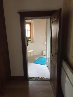 an open door into a room with a blue rug at appartement château de la Comtesse in Saint-Gervais-les-Bains