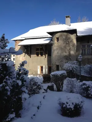 a house covered in snow with a yard at appartement château de la Comtesse in Saint-Gervais-les-Bains