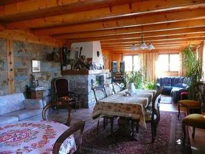 a living room with a table and a stone wall at Chalet Vaclav in Sixt