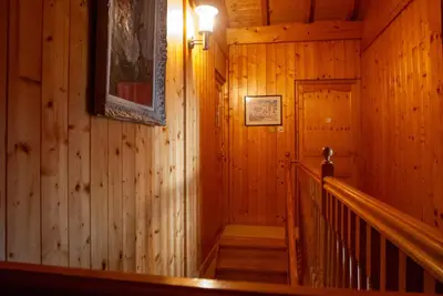 a staircase in a wooden cabin with a picture on the wall at Chalet Vaclav in Sixt