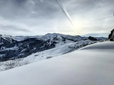 a view of a snow covered mountain with a lake at Chalet Vaclav in Sixt