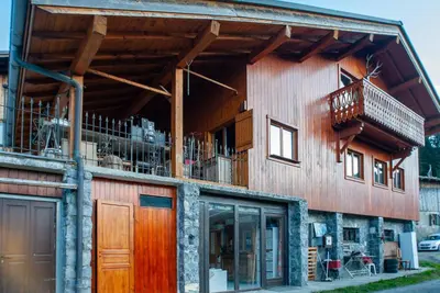 a building with a balcony on the side of it at Chalet Vaclav in Sixt