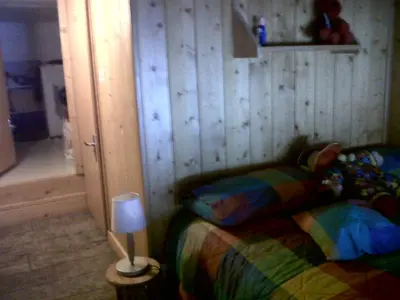 a bedroom with a bed with a lamp next to it at Flaine Forum i1 Cassiopée Duplex Mezzanines & Terrasse in Flaine