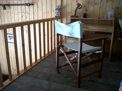 a chair sitting at a desk in a room at Flaine Forum i1 Cassiopée Duplex Mezzanines & Terrasse in Flaine