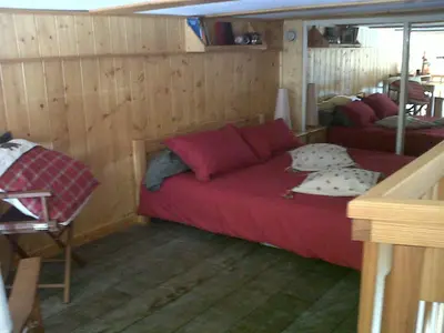 a room with a red bed in a room at Flaine Forum i1 Cassiopée Duplex Mezzanines & Terrasse in Flaine
