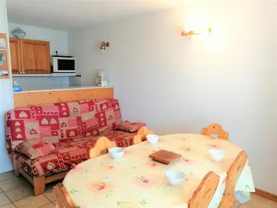 a kitchen with a table and a couch at Confortable 2 pièces avec cabine à Morillon 1100, balcon, 6 pers, wifi - FR-1-815-57 in Morillon