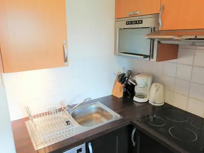 a kitchen and dining room with a table and chairs at Appartement 3 pièces pour 6 personnes avec parking à Morillon 1100 - FR-1-815-56 in Morillon