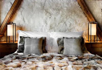 a bedroom with a large bed with two lamps at Chalet des Fermes de Marie, avec services, Collection Chalets des Fermes in Megève