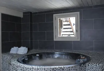 a bath tub in a bathroom with a window at Chalet des Fermes de Marie, avec services, Collection Chalets des Fermes in Megève