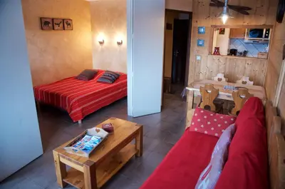 a living room with a bed and a table at Chamois in Chamonix-Mont-Blanc