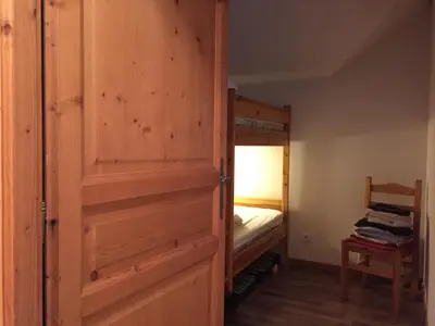 a door leading to a bedroom with a bunk bed at Le Grand Panorama 5 Étage Balcon Vue sur La Montagne in Saint-Gervais-les-Bains