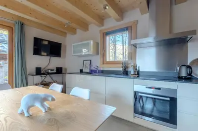 a kitchen with a table with a bear figurine on it at Le Chalet de l'Ours Blanc in Chamonix-Mont-Blanc