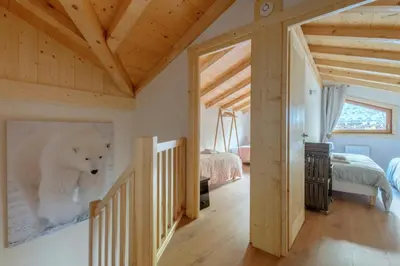 a bedroom with a large white polar bear on the wall at Le Chalet de l'Ours Blanc in Chamonix-Mont-Blanc