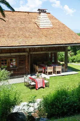 a pavilion with a table and chairs in front of a house at Chalet Chatel, avec services, Collection Chalets des Fermes - Megève in Megève