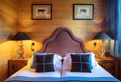 a bedroom with a large bed with two lamps at Chalet Chatel, avec services, Collection Chalets des Fermes - Megève in Megève