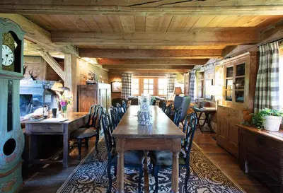 a dining room with a wooden table and chairs at Chalet Chatel, avec services, Collection Chalets des Fermes - Megève in Megève