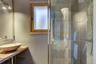 a bathroom with a glass shower and a sink at Chalet Sanaz in Chamonix-Mont-Blanc