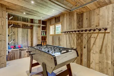 a large room with a foosball table in the middle at Chalet Sanaz in Chamonix-Mont-Blanc