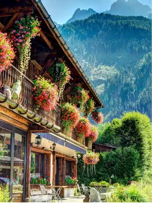 a building with flowers on the side of it at Auberge du Manoir in Chamonix-Mont-Blanc